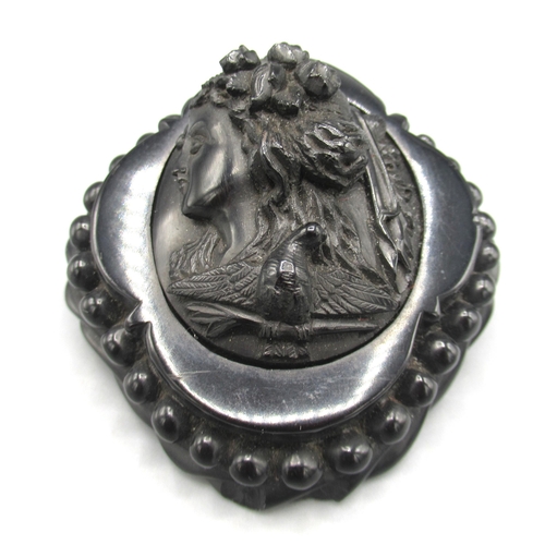 169 - Jet cameo brooch depicting a Greek woman in profile, surrounded by a beaded border, approx. 7cm x 7c... 