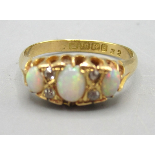 17 - 18ct yellow gold opal and diamond ring, the three cabochon opals separated by brilliant cut diamonds... 