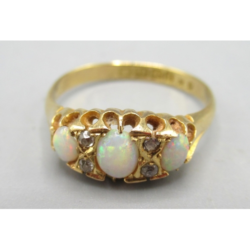 17 - 18ct yellow gold opal and diamond ring, the three cabochon opals separated by brilliant cut diamonds... 