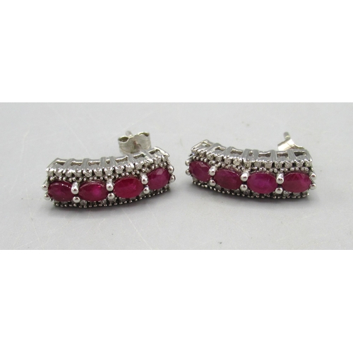 257 - Pair of 9ct white gold stud earrings set with rubies, stamped 375, 4.43g