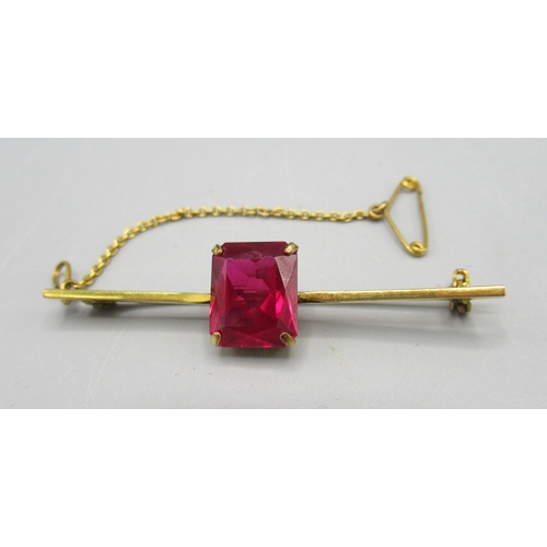 9 - 9ct yellow gold bar brooch set with large emerald cut ruby, stamped 375, 4.53g