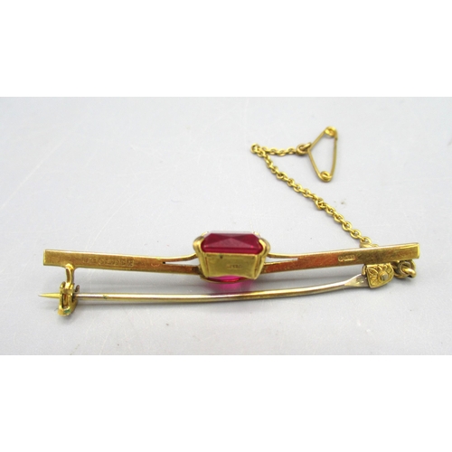 9 - 9ct yellow gold bar brooch set with large emerald cut ruby, stamped 375, 4.53g