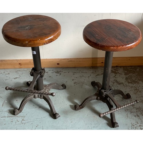 790 - Pair of adjustable machinist stools with an iron base and wooden seats, H62cm