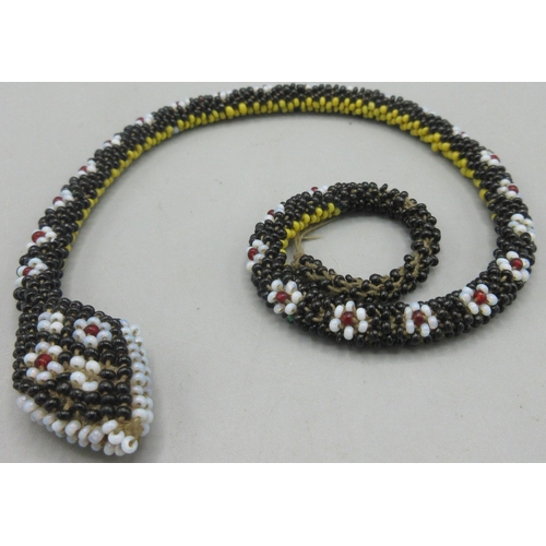 133 - Circa WWI Turkish prisoner of war beaded snake, with black yellow and floral-like beading, L34cm