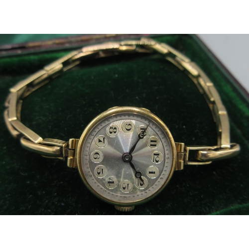 39 - Swiss 18ct gold ladies wristwatch with engine turned silver dial on 9ct rolled gold expanding bracel... 