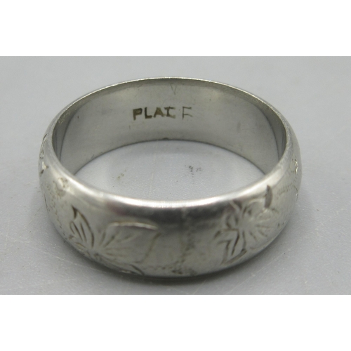 49 - Platinum band ring with engraved leaf decoration, stamped Plat, size J, 6.51g