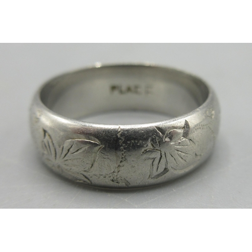 49 - Platinum band ring with engraved leaf decoration, stamped Plat, size J, 6.51g