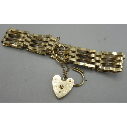 57 - 9ct yellow gold four bar gate bracelet with heart padlock and safety chain, stamped 375, D6cm ,9g