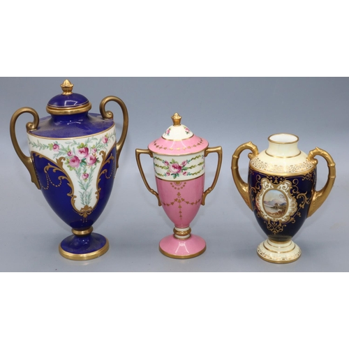 301 - Coalport porcelain two handled urn decorated with a lake scene vignette; Minton pink and gilt urn an... 