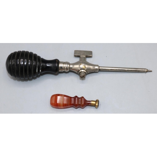 74 - Orange agate desk seal, L5cm, and an early 20th century champagne tap with ebonised handle (2)