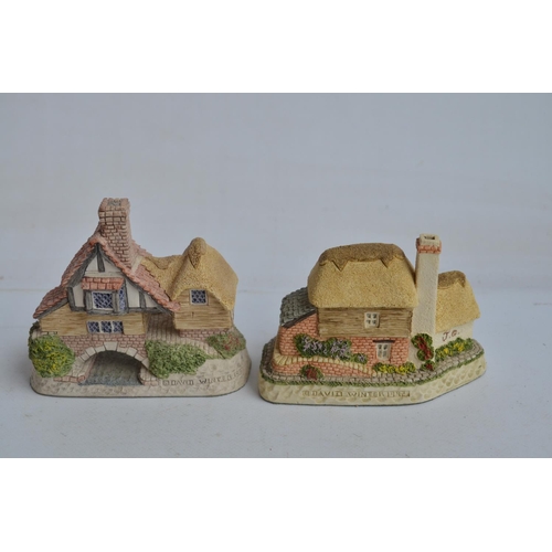 364 - Four boxed cottage models from David Winter to include Mr Fezziwig's Emporium (damage to chimney), O... 