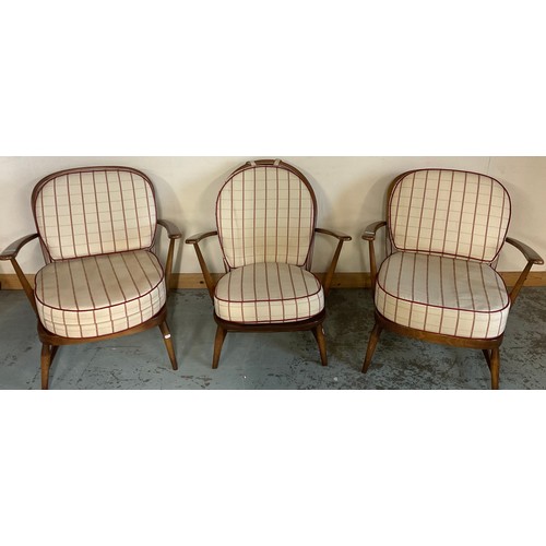 679 - Pair of Ercol stick back arm chairs and a similar arched back arm chair, all with loose cushions (3)