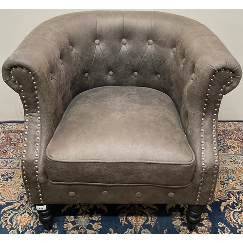 441 - Modern tub chair, upholstered in buttoned and nailed grey faux leather, on turned supports