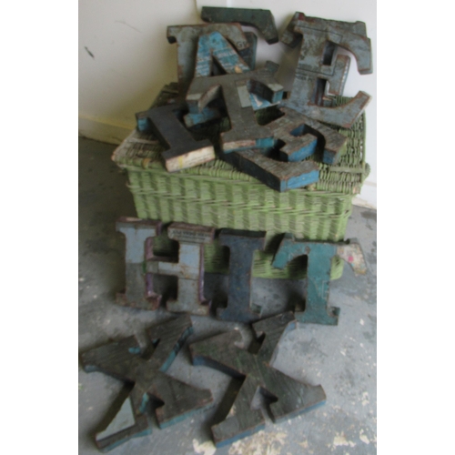 470 - Green painted wicker laundry basket and assorted tin plate letters