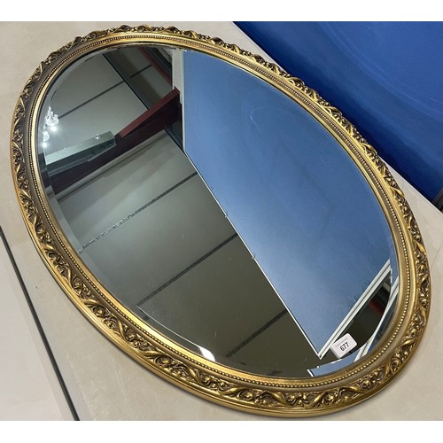 677 - Oval wall mirror bevelled plate in floral moulded gilt frame, 100cm x 67cm