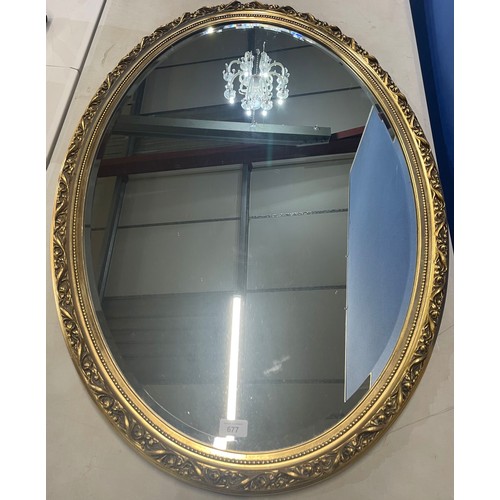 677 - Oval wall mirror bevelled plate in floral moulded gilt frame, 100cm x 67cm