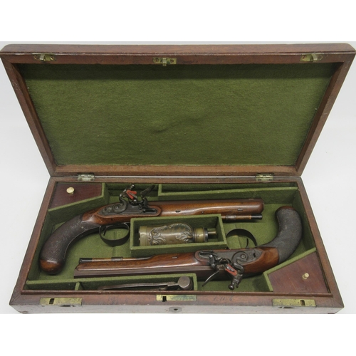 A Cased Pair Of 20-Bore Flintlock Duelling Pistols by Henry Nock, London, Circa 1800, 9" octagonal barrels with 'London' engraved to the top flat, locks engraved 'H. Knock' with side slide safeties and steel mounts with heavy chequered grips and ebony tipped ramrods, 14.5" overall, in fitted mahogany case with various accessories and inset brass carry handle, 45.5x22.5x7.5cm