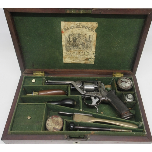 Cased Samuel Nock .376 percussion Tranter double trigger revolver, 4 inch octagonal barrel with engraved scroll borders, the tope engraved 'Sam l. Nock 116 Jermyn St. London' the frame with traces of original blue, numbered 4463T, and fitted with 'W. Tranter's Patent' removable rammer, five shot cylinder, the double trigger also stamped 'W. Tranter's Patent', chequered grips fitted with oval boss. The mahogany case with green lining and trade label with a large selection of various accessories