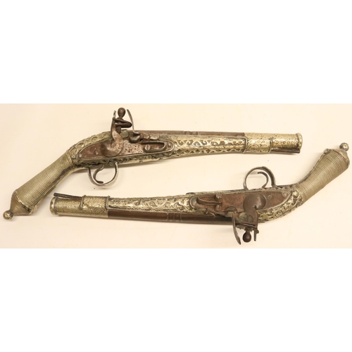 103 - Pair of Balkan silver covered decorative flintlock pistols, 9.5