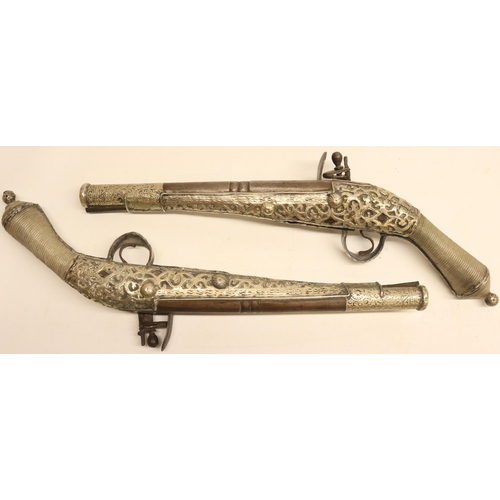 103 - Pair of Balkan silver covered decorative flintlock pistols, 9.5