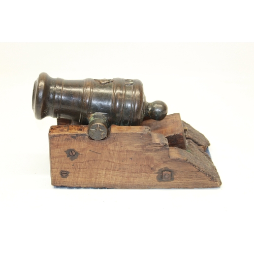 Unusual bronze cast small squat cannon, 6.5" staged ring bounded barrel with approx 1" bore diameter, top of barrel with the figure of a beaver, trunnions with star and crescent moon, mounted on stationary steeped wooed bed with adjustment wedge, 28cm overall