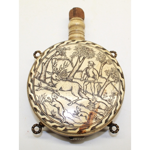 175 - Circular bone etched moon shaped powder flask in the Early 17th century style, decorated with huntin... 