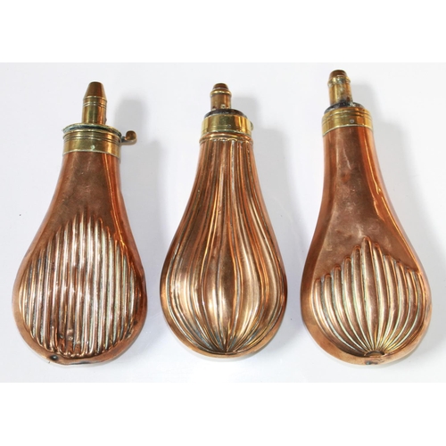 179 - Three brass and copper powder flasks, with ribbed design. One by Dixon and Sons