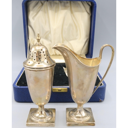 138 - Cased George V silver sugar caster and jug pair, both stood on square pedestal feet by Viner's Ltd, ... 