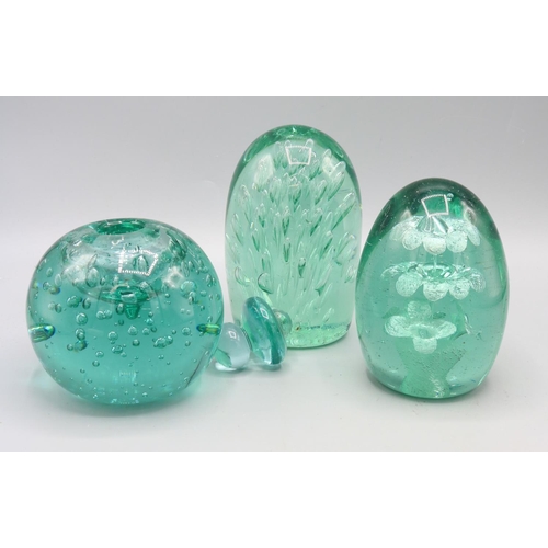 769 - Two Victorian glass dumps, one with sprays of air bubble and one with inset floral design, and a gla... 