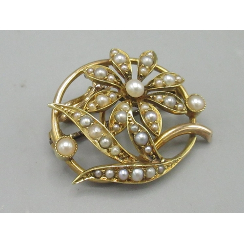 34 - 15ct yellow gold circular pendant brooch with floral detail, set with seed pearls, stamped 15ct, 5.4... 