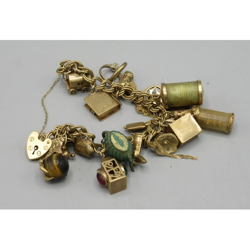 21 - Victorian 9ct yellow gold charm bracelet set with a quantity of charms, mostly 9ct stamped 375, but ... 