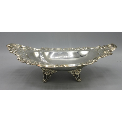 244 - Edwardian silver dish in oval form with pierced scrolling boarders and flowers cast in relief, stood... 