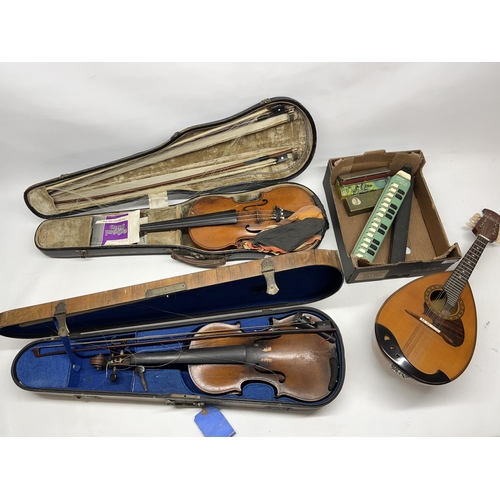 781 - Collection of musical instruments, incl. two early 20th century violins, a Suzuki mandolin, harmonic... 