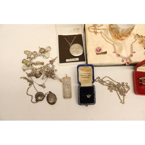 141 - Collection of silver jewellery including three locket necklaces, charm bracelet, silver ingot, and a... 