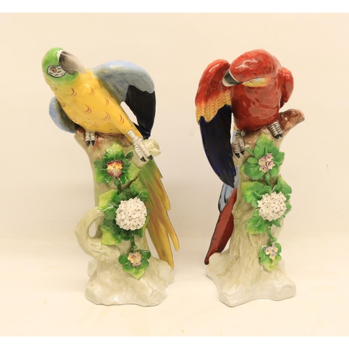 90 - Pair of 20th Century Sitzendorf figures, each depicting a brightly coloured Macaw perched on a folia... 