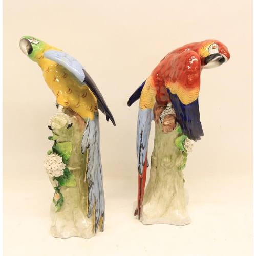 90 - Pair of 20th Century Sitzendorf figures, each depicting a brightly coloured Macaw perched on a folia... 