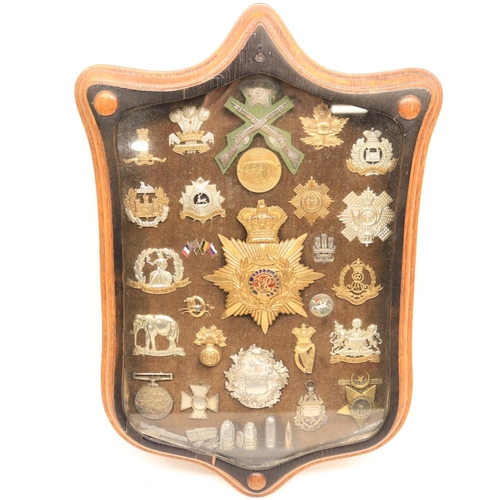 96 - Framed collection of military badges from various regiments and countries including, Khedive's Egypt... 