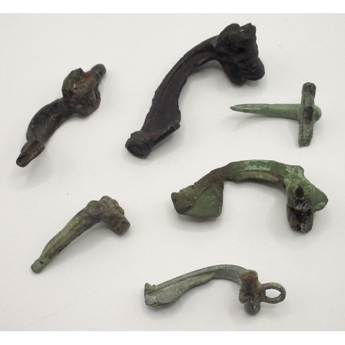 335 - Selection of five Romano-British style 'trumpet' brooches and a medieval-style cabinet handle