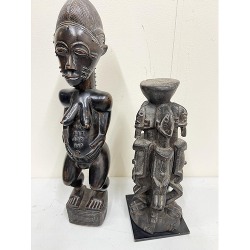 655 - East African carved hardwood fertility figure, 39cm and African carved hardwood stand, H28cm