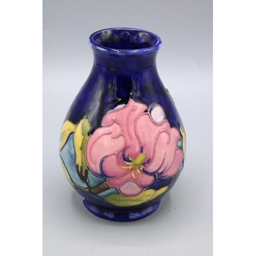 662 - Moorcroft Magnolia baluster vase, dark blue ground, tube lined floral decoration, signature to base,... 