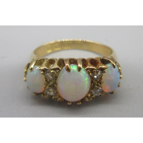 27 - 18ct yellow gold opal and diamond ring, the three cabochon opals separated by brilliant cut diamonds... 