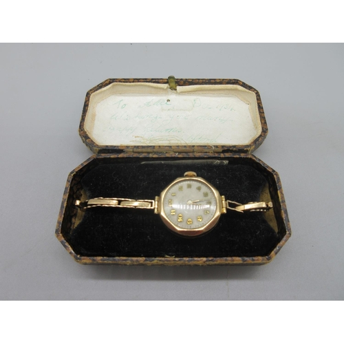 666 - Swiss lady's 9ct gold wristwatch on period 9ct gold expanding bracelet stamped .375,silvered dial wi... 