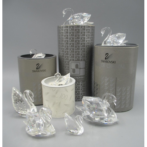 229 - Swarovski swans, a large, a medium and a small, in boxes and another two large, medium and two small... 