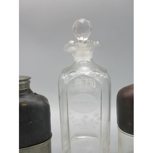 1168 - Two Edwardian hip flasks with leather covered shoulders, and a 19th century engraved 'Gin' decanter,... 