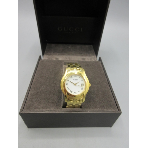 522 - Gucci 2001 lady's gold plated quartz wristwatch with date on integrated bracelet with signed deploym... 