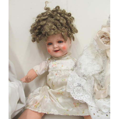 235 - Twelve dolls, collection of doll parts and a collection of doll clothes (4 boxes)