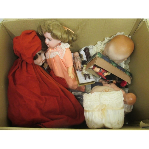 235 - Twelve dolls, collection of doll parts and a collection of doll clothes (4 boxes)