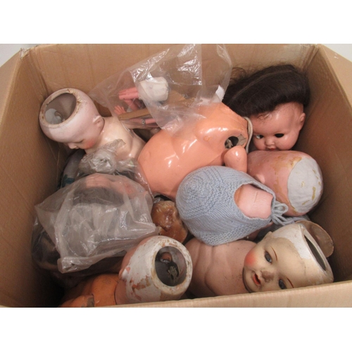 235 - Twelve dolls, collection of doll parts and a collection of doll clothes (4 boxes)