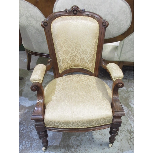 132 - Victorian walnut framed open arm chair, upholstered back and seat on turned supports with ceramic ca... 