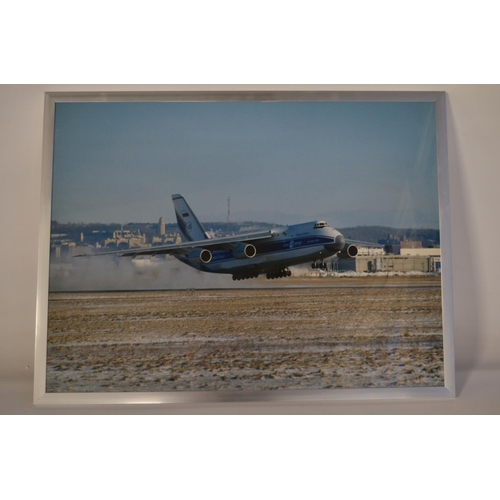 13 - Collection of Volga-Dnepr framed pictures and prints (largest example 141x89cm) and an inhouse produ... 